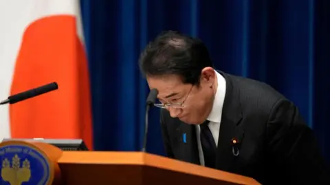 Getty Images Japan's Prime Minister Fumio Kishida bows at the end of a news conference at the prime minister's office in Tokyo on June 13, 2023. 