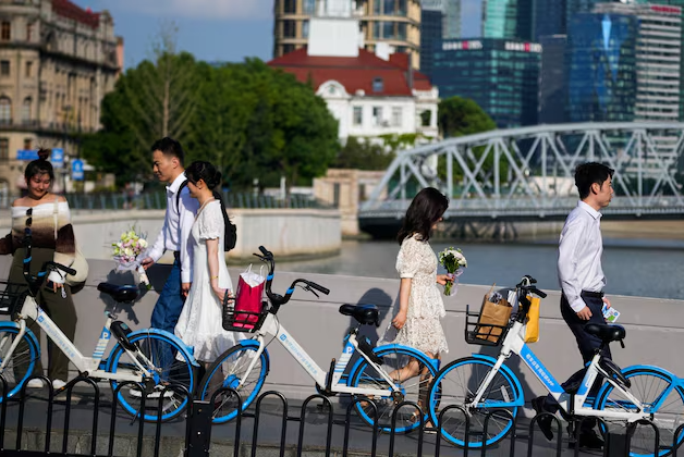 couples prepare to get their photo taken during a wedding photography shoot on a street in shanghai china september 6 2023 photo reuters