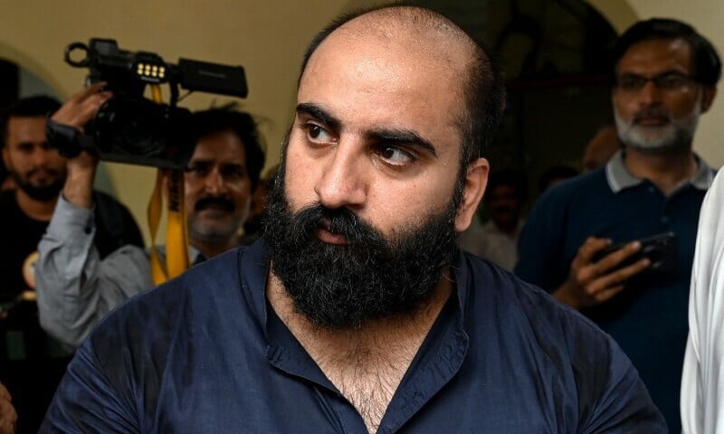 federal investigation agency escorts farhan asif arrested for cyber terrorism to a court in lahore on august 22 photo afp