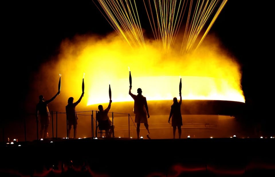 charles antoine kouakou nantenin keita fabien lamirault alexis hanquinquant and elodie lorandi lit the olympic cauldron during paris 2024 paralympics opening ceremony in paris france on august 28 2024 photo reuters