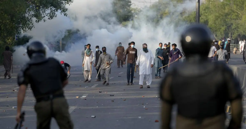 protestors throw stones after police fire tear gas to disperse them in lahore on may 9 2023 photo reuters