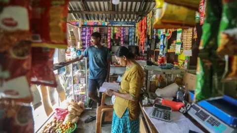 EPA Vendors wait for customers at a grocery shop in Colombo, Sri Lanka, 13 September 2024.