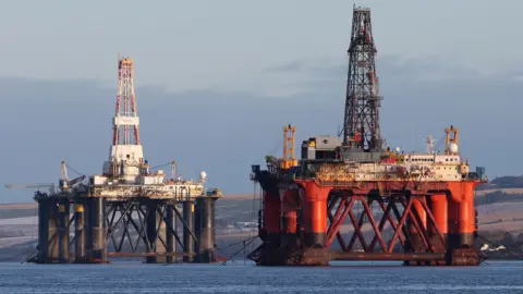 PA Media An oil platform standing amongst other rigs that have been left in the Cromarty Firth near Invergordon in the Highlands of Scotland.