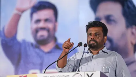   EPA-EFE/REX/SHUTTERSTOCK Anura Kumara Dissanayake speaks to his supporters during a campaign rally