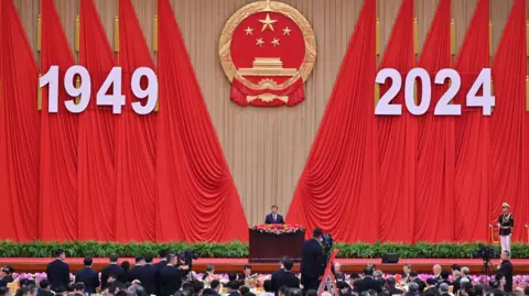 Getty Images China's President Xi Jinping speaks during a National Day reception on the eve of the 75th anniversary of the People's Republic of China.