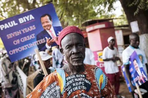 Getty Images A supporters of President Paul Biya poses for a photograph in Maroua, Far North Region of Cameroon, after the election rally of the Cameroonian president on September 29, 2018