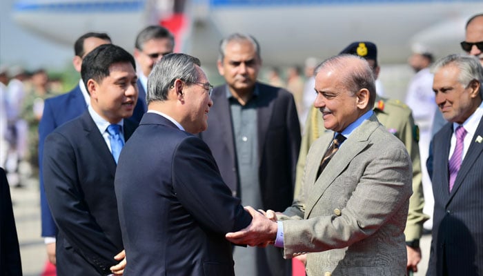 Prime Minister Shehbaz Sharif (right) welcomes Chinese Premier Li Qiang as he arrives at Nur Khan Airbase in Rawalpindi, on October 14, 2024. — PMO