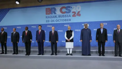 Getty Images Ethiopian Prime Minister Abiy Ahmed, Egyptian President Abdel Fattah al-Sisi, South African President Cyril Ramaphosa, Chinese President Xi Jinping, Russian President Vladimir Putin, Indian Prime Minister Narendra Modi, The United Arab Emirates' President Sheikh Mohamed bin Zayed Al Nahyan, Iran's President Masoud Pezeshkian and Brazilian Foreign Minister Mauro Vieira pose for a family photo during the BRICS summit in Kazan on October 23, 2024. (Photo by MAXIM SHIPENKOV / POOL / AFP) (Photo by MAXIM SHIPENKOV/POOL/AFP via Getty Images)