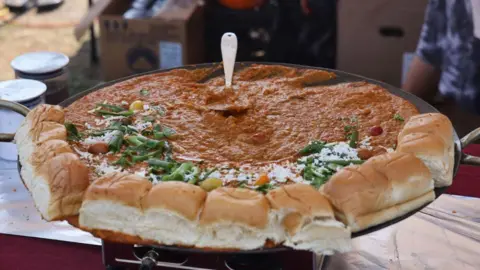 Getty Images Pav Bhaji is at a food stall during the Sree Ganesh Chaturthi Mahotsav festival in Brampton, Ontario, Canada, on September 14, 2024. Pav Bhaji is a street food from Mumbai. It is a blend of spicy mashed vegetables served with butter-toasted buns. (Photo by Creative Touch Imaging Ltd./NurPhoto via Getty Images)