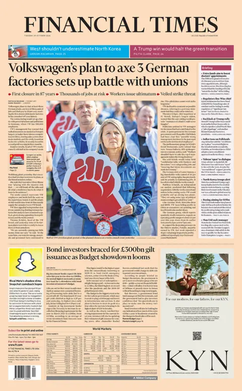 The headline in the Financial Times reads: "Volkswagen's plan to axe 3 German factories sets up battle with unions". 