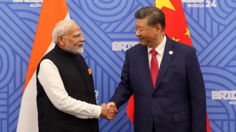 Reuters Indian Prime Minister Narendra Modi shakes hands with Chinese President Xi Jinping before their meeting on the sidelines of the BRICS summit in Kazan, Russia, October 23, 2024. India's Press Information Bureau/Handout via REUTERS THIS IMAGE HAS BEEN SUPPLIED BY A THIRD PARTY. NO RESALES. NO ARCHIVES.
