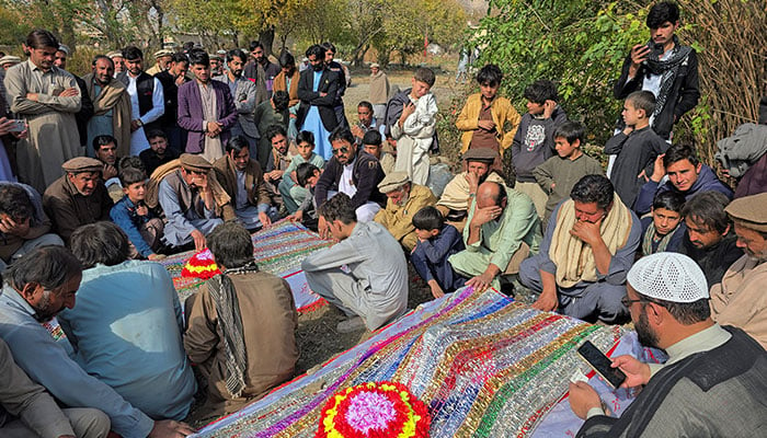 People mourn over the graves of relatives who were killed after gunmen opened fire on passenger vehicles in the Kurram tribal district of Khyber Pakhtunkhwa, in Shalozan, November 22, 2024. — Reuters