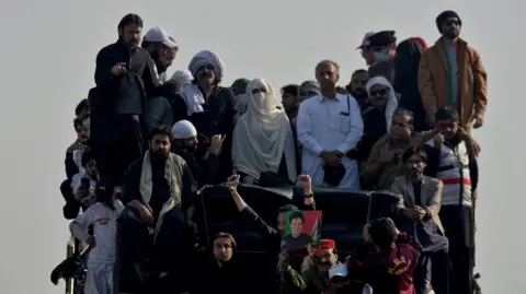 Reuters Bushra Bibi, wife of jailed former Pakistani Prime Minister Imran Khan, and supporters of Khan's party Pakistan Tehreek-e-Insaf (PTI) attend a rally demanding his release, in Islamabad, Pakistan, November 26, 2024.