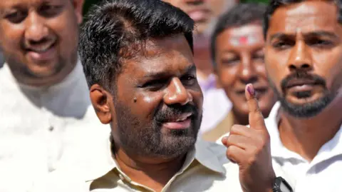 Reuters President Anura Kumara Dissanayake talking to his supporters after casting his vote