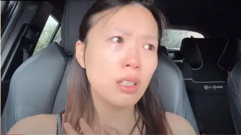 Youtube / Kasumi Law Screenshot of Kasumi Law's Youtube video that went shows her tearful and sitting in her car.