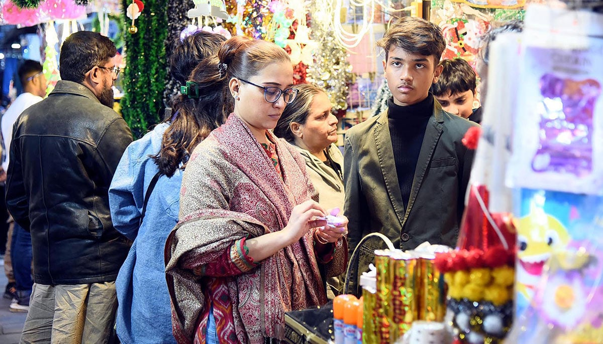 A woman looks for decoration items at a shop ahead of the Christmas festival celebrations on December 21, 2024 in Rawalpindi. — NNI