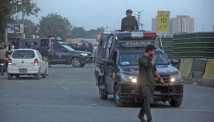 Police personnel stand alert during Majlis Wahdat-e-Muslimeen sit-in protest at Numaish Chowrangi, Karachi, December 29, 2024. — Online