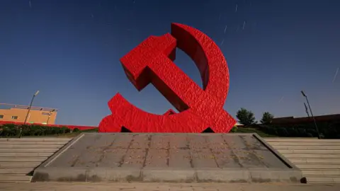 Getty Images A sculpture of the Chinese Communist Party logo - a hammer and sickle in red.  