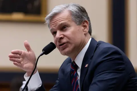 EPA A grey-haired main in front of a microphone, gesturing with his hand