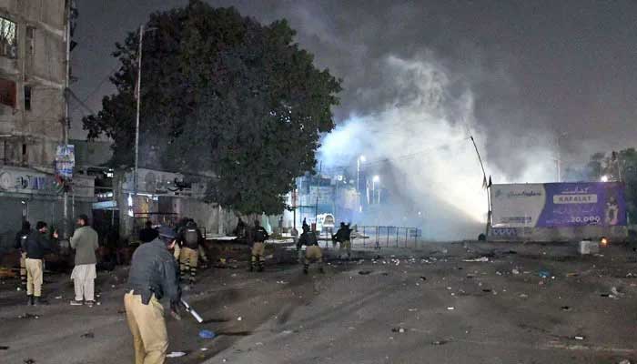 Police personnel fire tear gas shells on supporters of the MWM during sit-in in Karachi on December 31, 2024. — Online