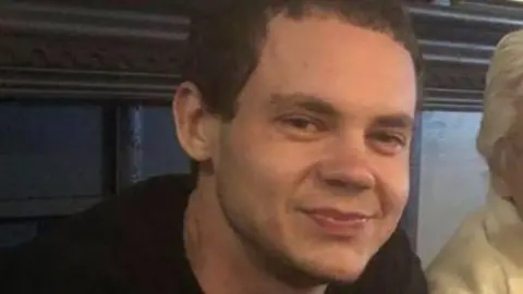 gofundme Matthew Tenedorio, who has short brown hair, is pictured smiling at the camera while at a restaurant