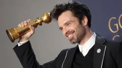 Getty Images  Sebastian Stan, winner of Best Performance by a Male Actor in a Motion Picture – Musical or Comedy Award for “A Different Man” poses in the press room during the 82nd Annual Golden Globe Awards at The Beverly Hilton on January 05, 2025 in Beverly Hills, California