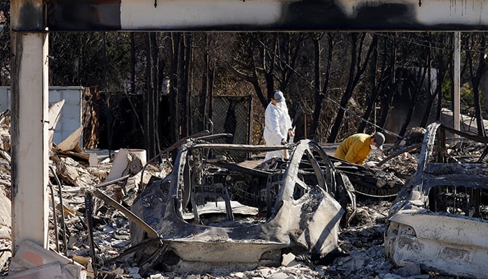 Residents dig through the remains of their home in the Pacific Palisades, after the Palisades Fire burned many homes, in Los Angeles County, California, US, January 12, 2025. — Reuters