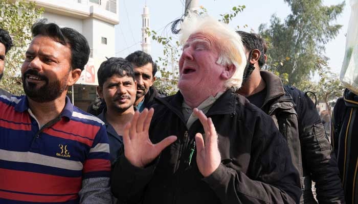 Saleem Bagga, seen by some as a lookalike of US President-elect Donald Trump, sings songs while selling kheer, a traditional South Asian rice pudding, along a road in Sahiwal, Pakistan January 13, 2025. — Reuters