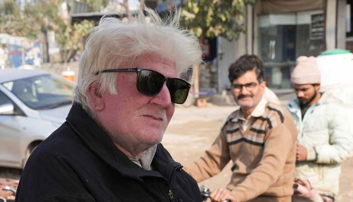 Saleem Bagga, seen by some as a lookalike of US President-elect Donald Trump, sings songs while selling kheer, a traditional South Asian rice pudding, along a road in Sahiwal, Pakistan January 13, 2025. — Reuters