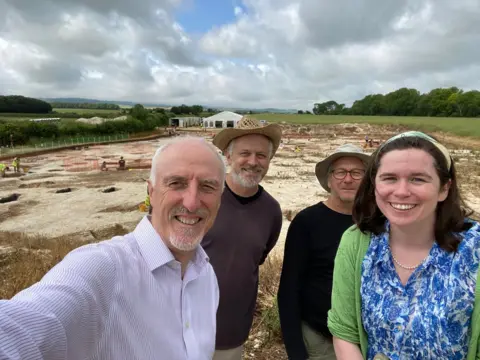 Bournemouth University Four people in a field at an archaelogical dig in Dorset