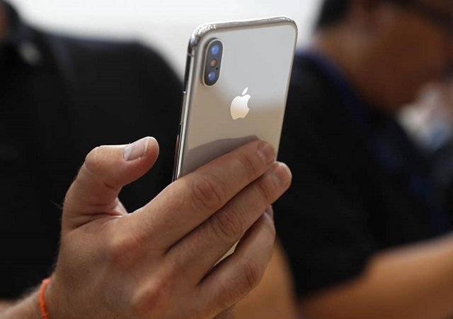 an attendee checks out a new iphone x during an apple launch event in cupertino california us september 12 2017 photo reuters