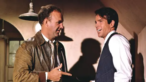 Getty Images Actors Warren Beatty (right) as Clyde Barrow and Gene Hackman as Buck Barrow in the film 'Bonnie and Clyde', 1967. (Photo by Silver Screen Collection/Getty Images)