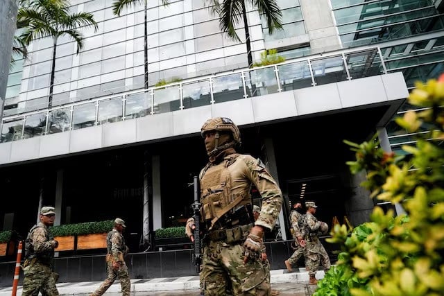 members of panama s national aeronaval service police senan stand outside the hotel where migrants from asia and the middle east are housed after being deported to panama as part of an agreement between the administration of us president donald trump and the central american nation in panama city panama on february 18 2025 photo reuters