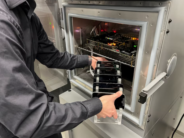 an engineer at apple loads iphone 16e phones into a chamber that tests the performance of the company s c1 cellular modem system under a wide range of temperatures for extended periods at an apple lab in sunnyvale california us february 18 2025 reuters