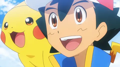 The Pokemon Company Two characters from Pokémon, one in yellow and one in blue, with both of them open mouthed smiling.