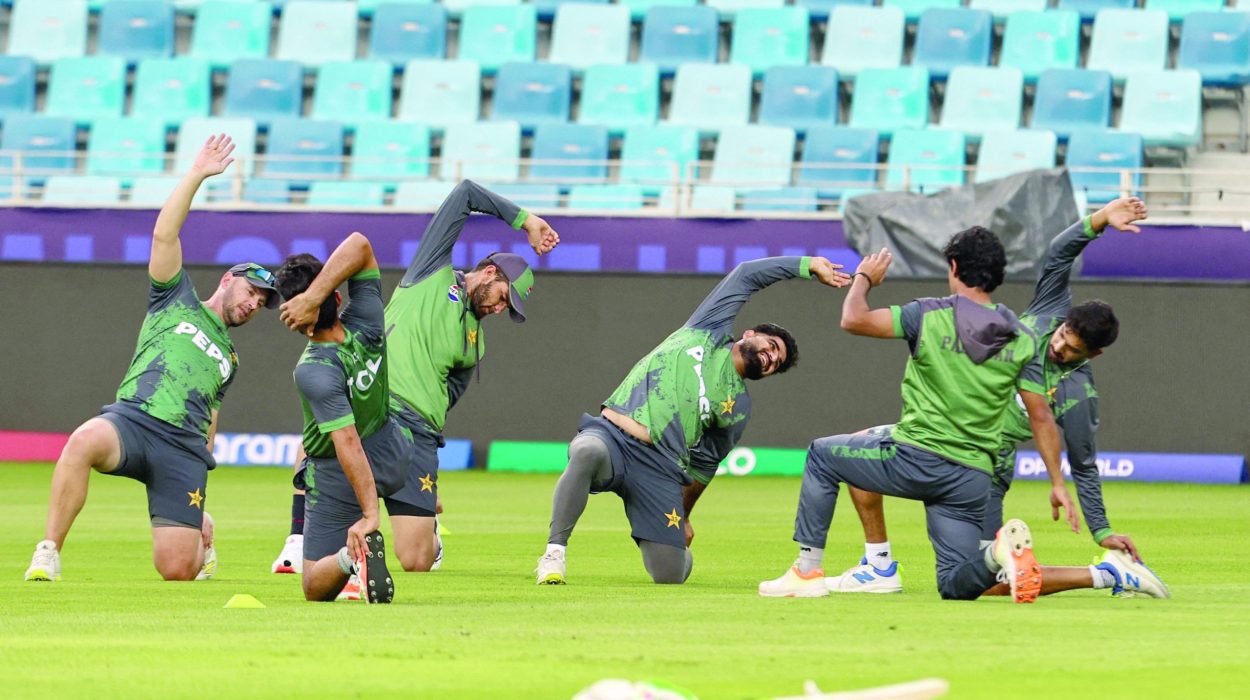 pakistan s players stretch during a practice session at the dubai international stadium on eve of their champions trophy match against india photo afp