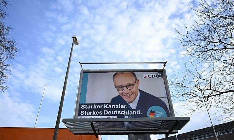 a billboard with an election campaign poster for germany s conservative christian democratic union party featuring their leader and top candidate for chancellor friedrich merz is pictured in dortmund germany on february 21 ahead of the country s federal elections photo afp