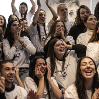 friends and family of israeli hostage omer shem tov celebrate as they watch his televised release by hamas at his family home in tel aviv photo afp