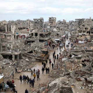 palestinians walk past the rubble of buildings destroyed during the israeli offensive on a rainy day amid a ceasefire between israel and hamas in gaza on february 6 2025 photo reuters