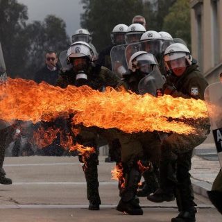 a molotov cocktail ignites striking a riot police officer at a protest near the greek parliament marking the second anniversary of the country s worst railway disaster as an investigation continues in athens greece february 28 photo reuters