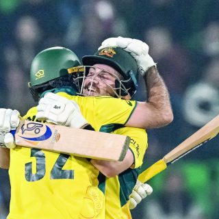 australia s josh inglis r celebrates with teammate maxwell after scoring a century during the icc champions trophy one day international odi against england at the gaddafi stadium in lahore on february 22 photo afp