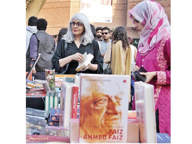 visitors skim through books on sale during the faiz festival at alhamra in lahore photo online