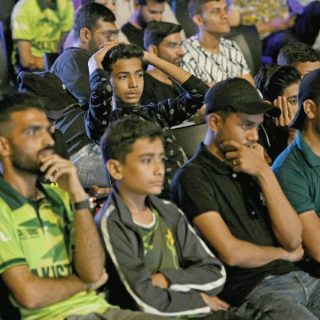 cricket fans in karachi react as they watch a live broadcast of the icc champions trophy match between india and pakistan on a big screen on sunday night photo afp