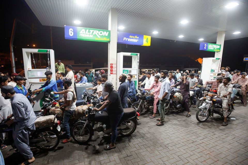 people wait their turn to get fuel at a petrol station in karachi pakistan june 2 2022 picture taken june 2 2022 photo reuters