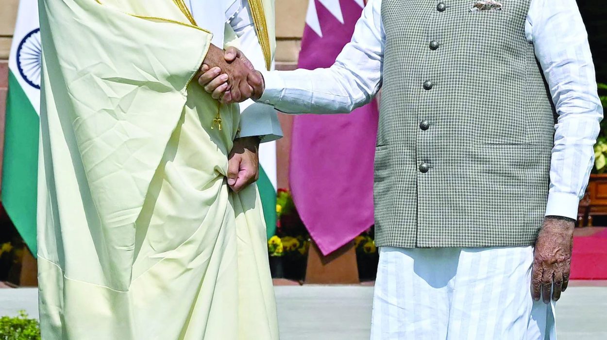 qatar s emir sheikh tamim bin hamad al thani shakes hands with india s prime minister narendra modi in new delhi photo afp