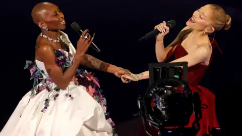 Getty Images HOLLYWOOD, CALIFORNIA - MARCH 02: (L-R) Cynthia Erivo and Ariana Grande perform onstage during the 97th Annual Oscars at Dolby Theatre on March 02, 2025 in Hollywood, California. (Photo by Kevin Winter/Getty Images)
