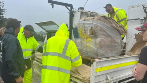 Authorities deliver sandbags to areas on the path of Cyclone Alfred in Queensland Australia