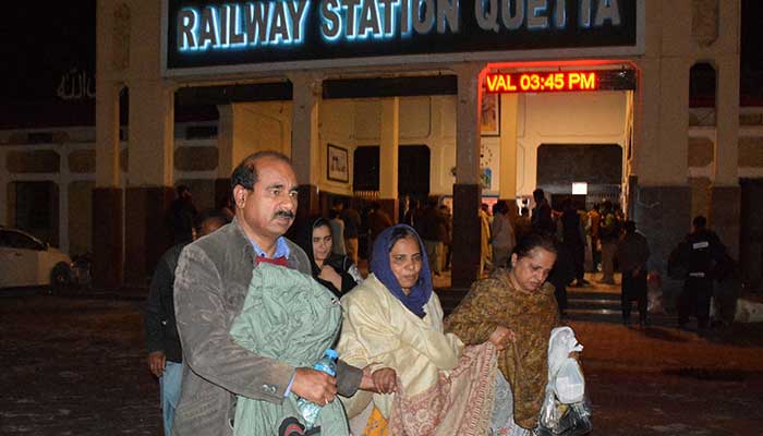 Passengers who were rescued from a train after it was attacked by militants, walk with their belongings at the Railway Station in Quetta, Balochistan, March 12, 2025. — Reuters 