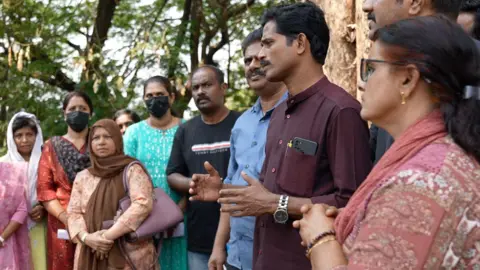 Vishnu Vardhan The image shows a men and women care workers in Kothamangalam town in Kerala, talking about the millions they lost while trying to obtain a care visa. 