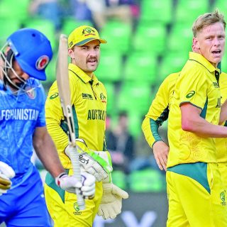 australia s nathan ellis r celebrates with teammates after dismissing afghanistan s gulbadin naib l in the icc champions trophy match at gaddafi stadium on friday photo afp